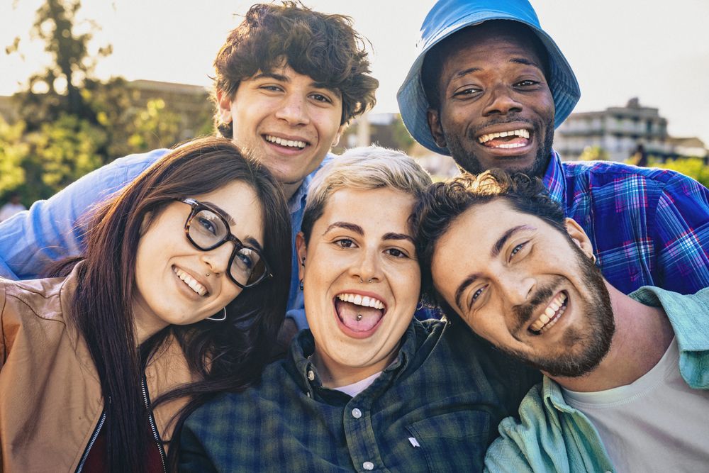 Happy friends smiling outdoors on a sunny day