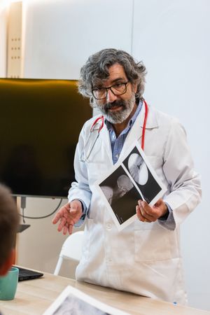 Doctor discussing x ray with colleagues in hospital