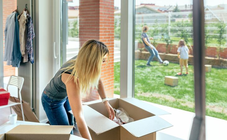 Woman unpacking moving boxes