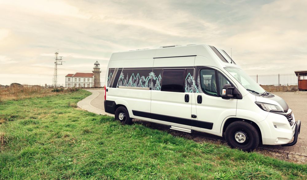 Van parked on road heading to light house on beautiful overcast morning
