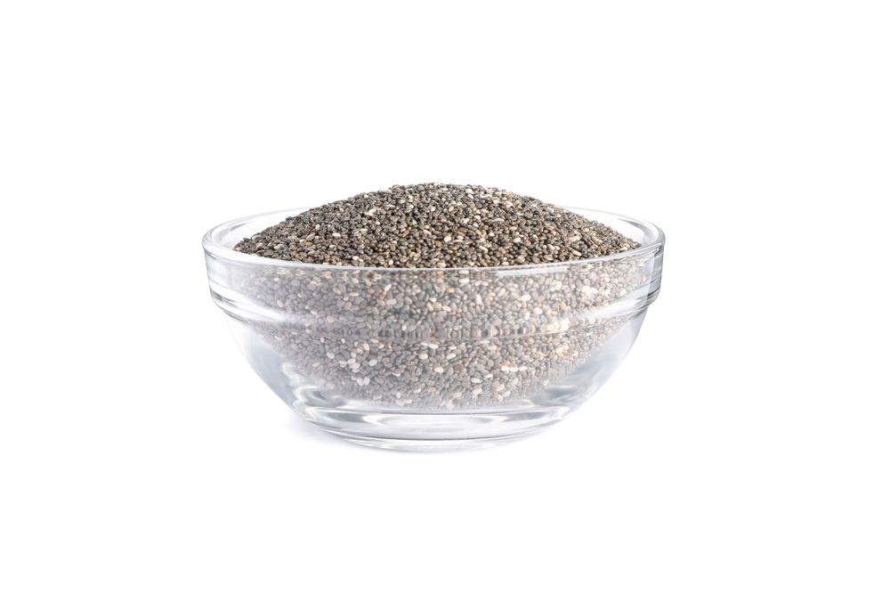 Chia seeds in glass bowl isolated on blank background