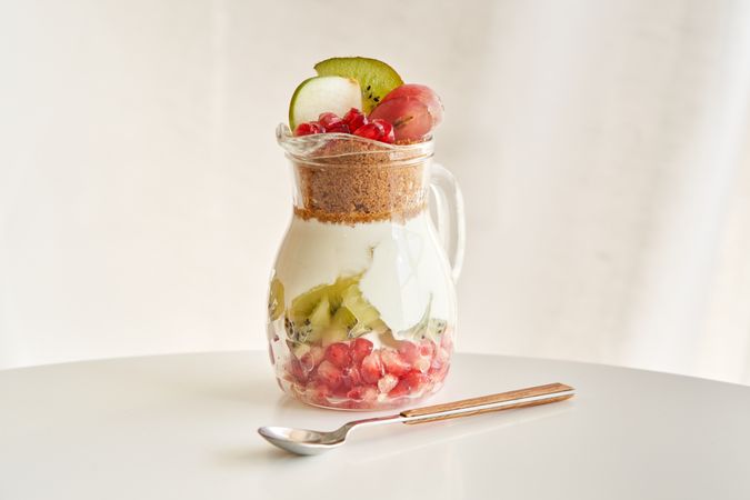 Delicious yogurt dessert with pomegranate, kiwi, grape and ginger biscuit