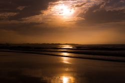 Beautiful evening sky over waving sea and shore