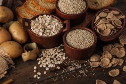Wholegrain food and freshly baked rye bread on table
