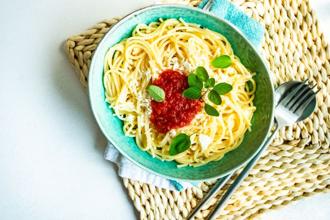 Pasta with tomato sauce on rattan placemat