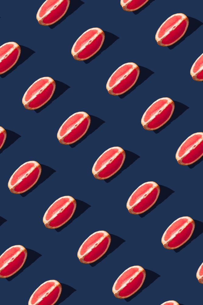 Pattern of grapefruit slices on navy  background