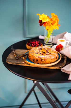 Freshly baked fruit cake on tray served with coffee