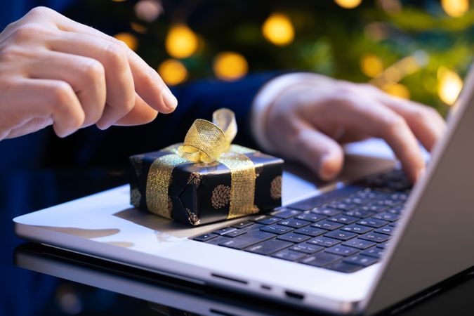 Businessman Reaching for Christmas Gift