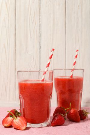 Composition with strawberry cocktails on pink table. Summer drink