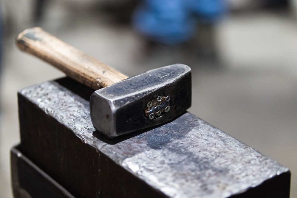 Hammer on workbench in blacksmith workshop
