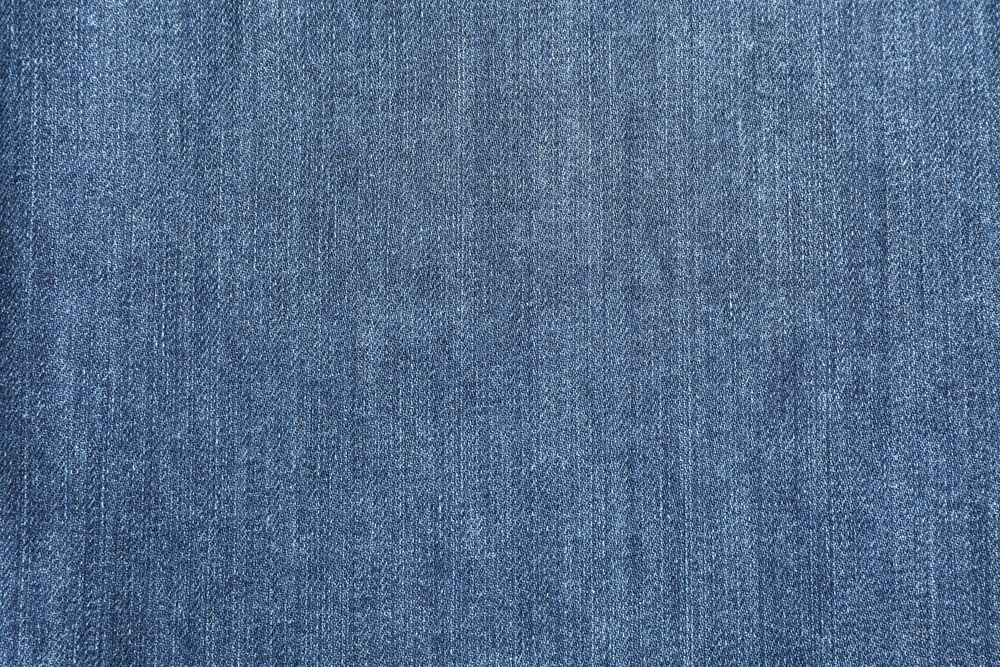 Texture of blue jeans as background, space for text