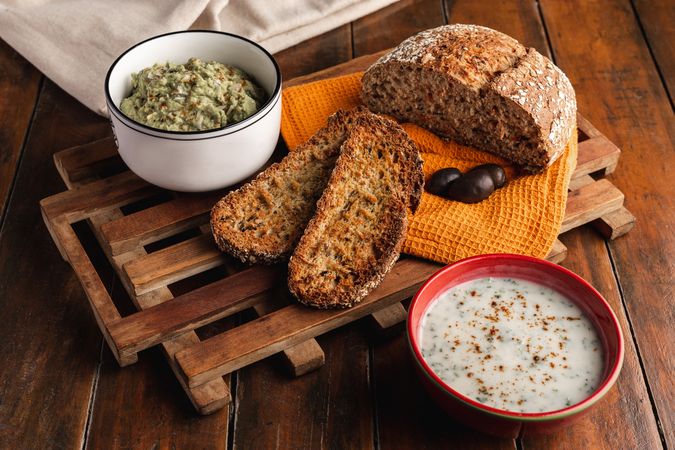 Tasty sauces decorated with sesame seeds and lush bread