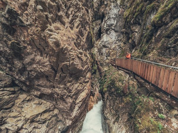 Traveller enjoying picturesque view of mountain ridge