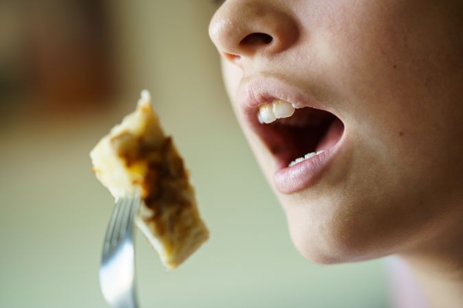 Girl eating bite of fritata