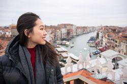 Content Asian female tourist at old city with waterlines