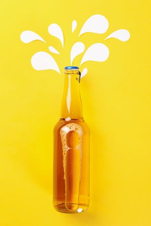 Blank bottle of beer on yellow background