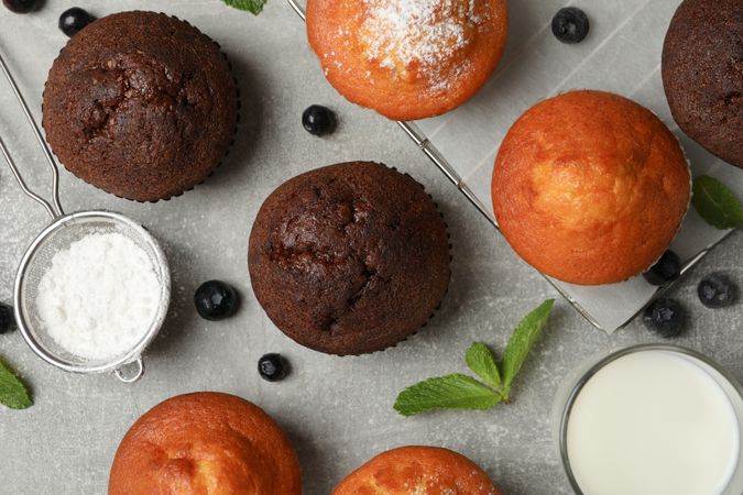 Composition with delicious muffins on gray background, top view