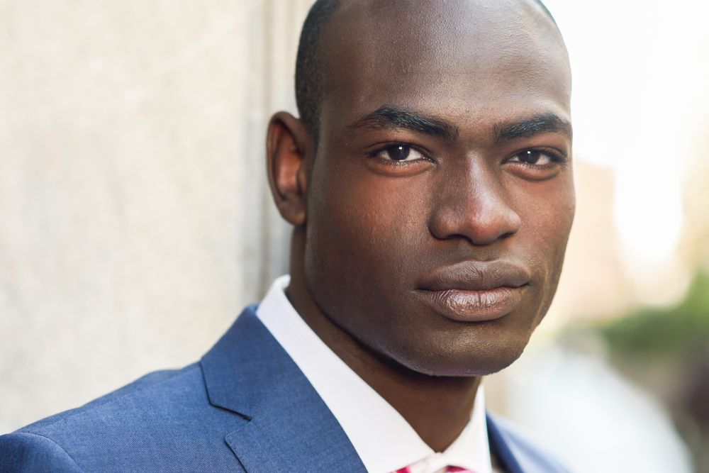 Close up picture of male looking at camera while wearing business attire