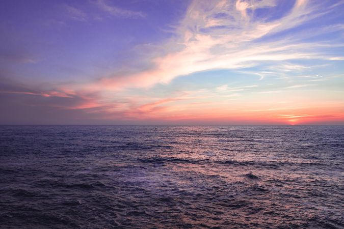 Looking out at horizon of the Pacific Ocean during sunset