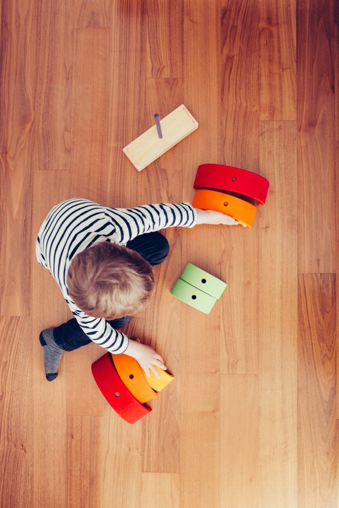 Boy playing with wooden construction pieces