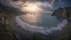 Beautiful bay around rocks and cloudy sunset