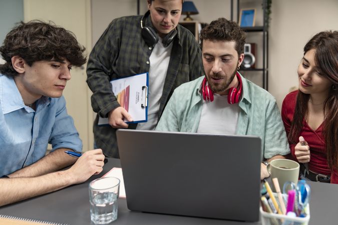Diverse business team collaborating on a project in a modern startup office.