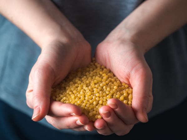 ptitim pasta or couscous in female hands