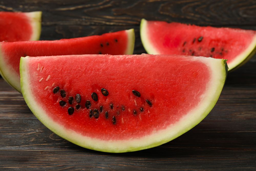Composition with watermelon slices on wooden background. Summer fruit