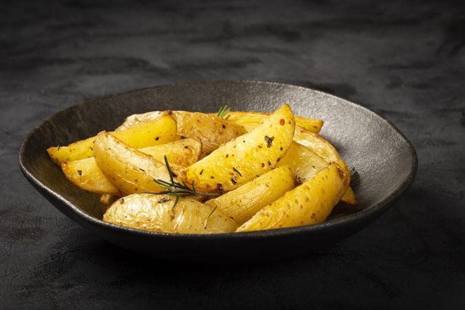 Roasted potatoes with rosemary on the plate.