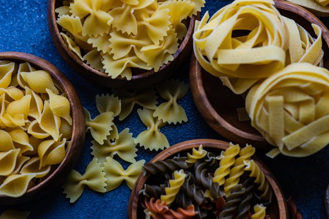 Variety of bowls of dry Italian pasta