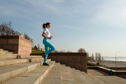 Young woman running on city streets