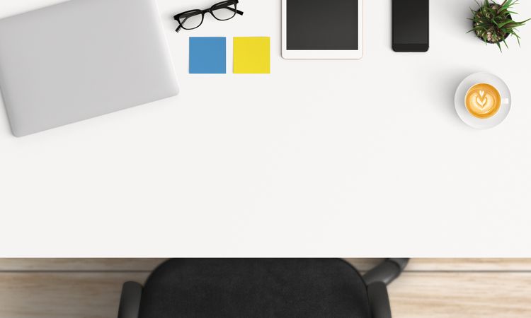 Modern workplace with laptop, coffee cup and smartphone or tablet copy space on table background. Top view. Flat lay style.