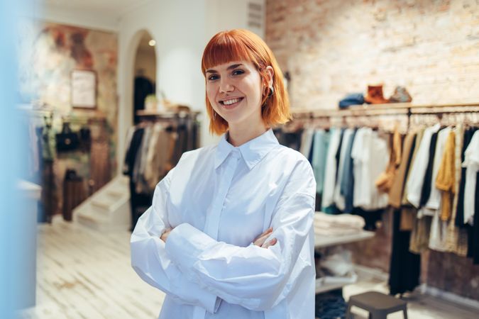 Portrait of confident woman standing in her boutique