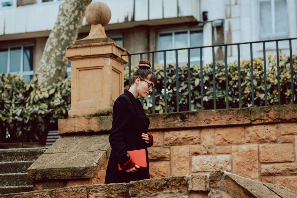 Young woman with book on steps