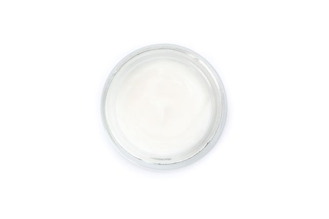Cosmetic cream in glass jar isolated on plain background