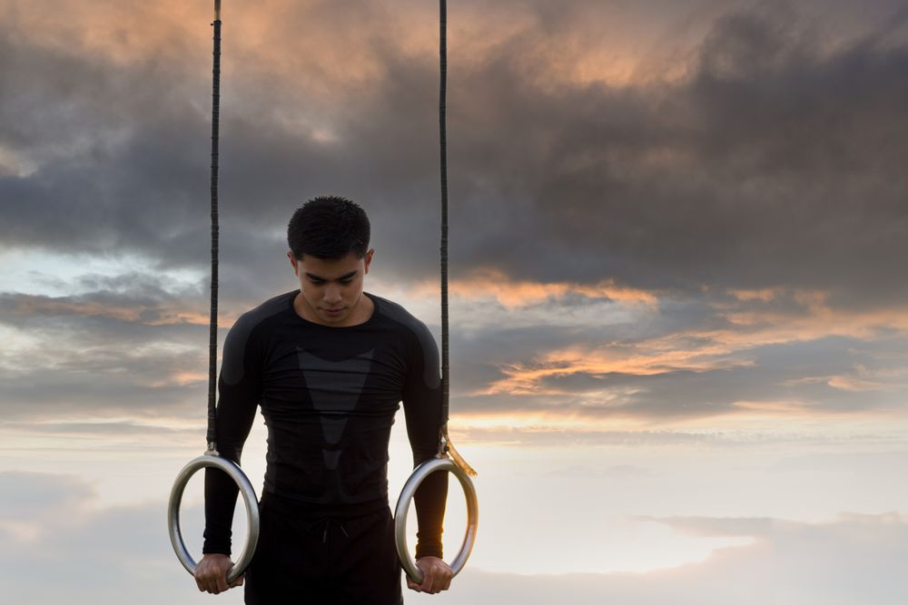 Sportsman training on gymnastic rings