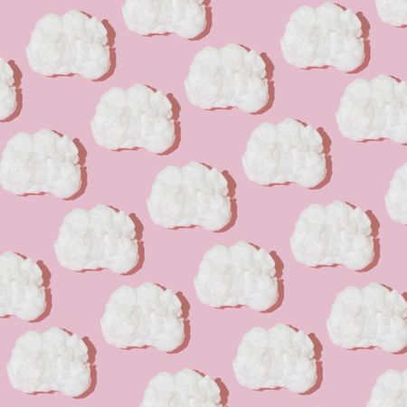 Pattern of cotton clouds on pink background
