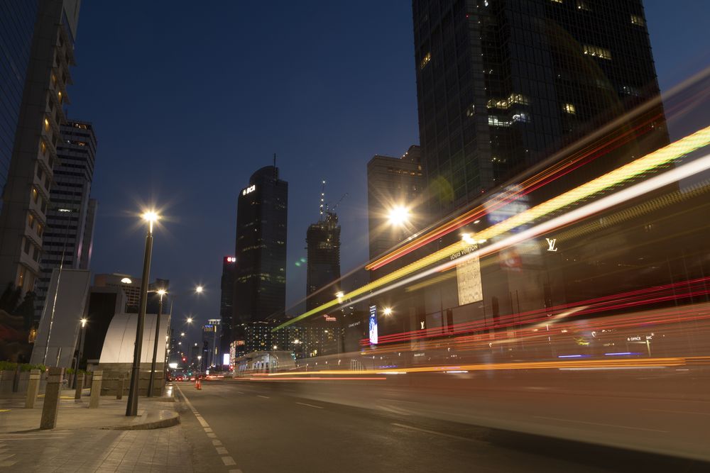 Jakarta, Indonesia - Oct 20, 2019: Night traffic lights in downtown Jakarta, between skyscrapers