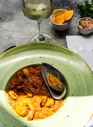 Risotto with sea food served with chilled wine