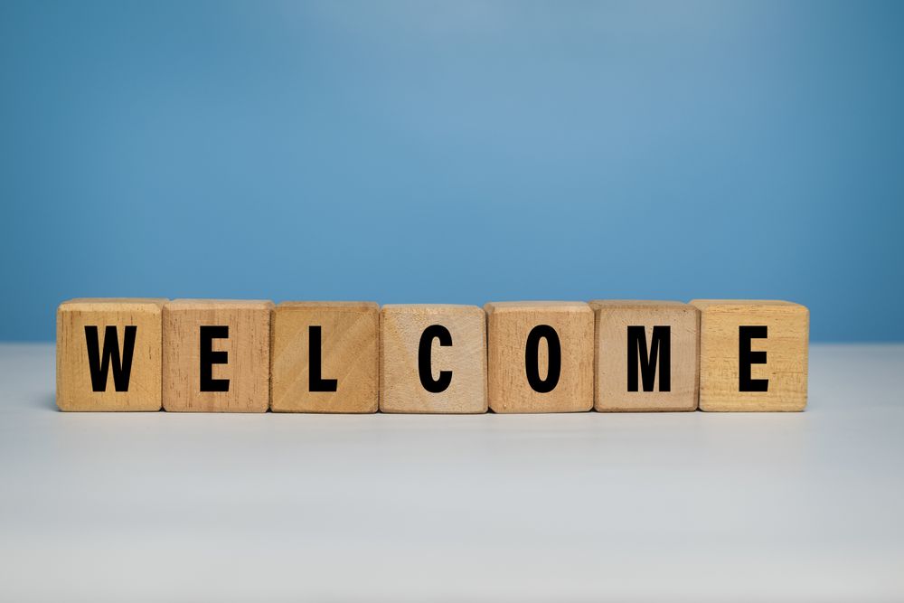welcome word on wooden blocks isolated on blue background