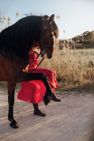 Anonymous female walking with horse