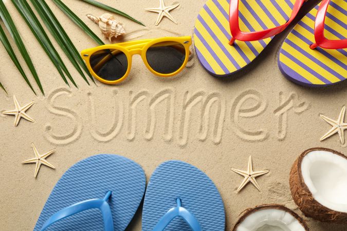 Composition with vacation accessories and inscription Summer on sea sand background