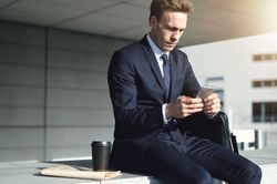 Man uses his smartphone while on coffee break