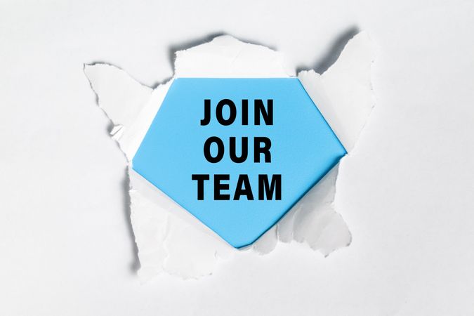 join our team words text message on torn paper over yellow background. concept of business hiring employee