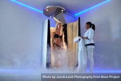 Cryotherapy technician giving client a treatment 5kRvoo