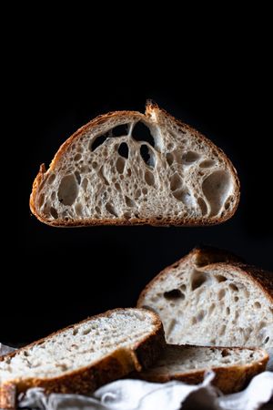 Slices of fresh bread falling on table