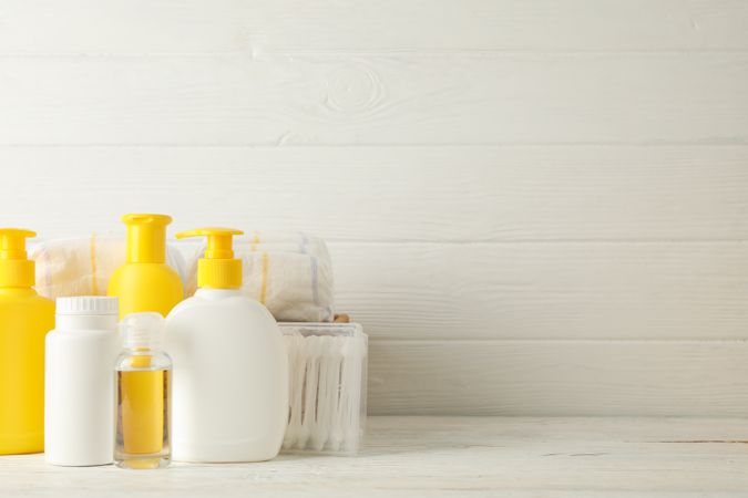 Baby hygiene accessories on wooden background