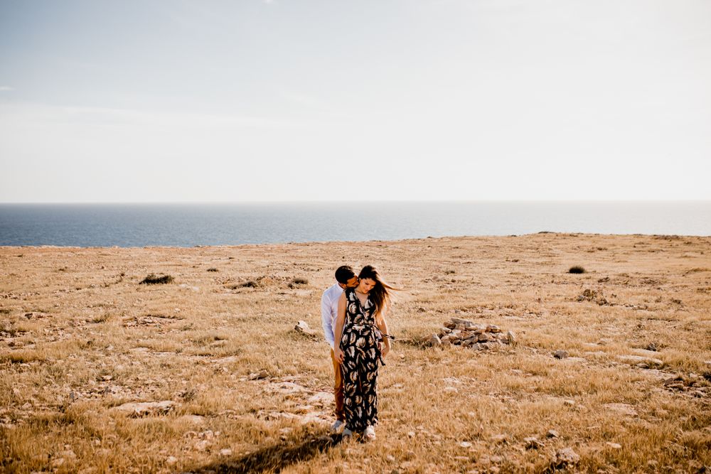 Peaceful lovers bonding on empty coastline