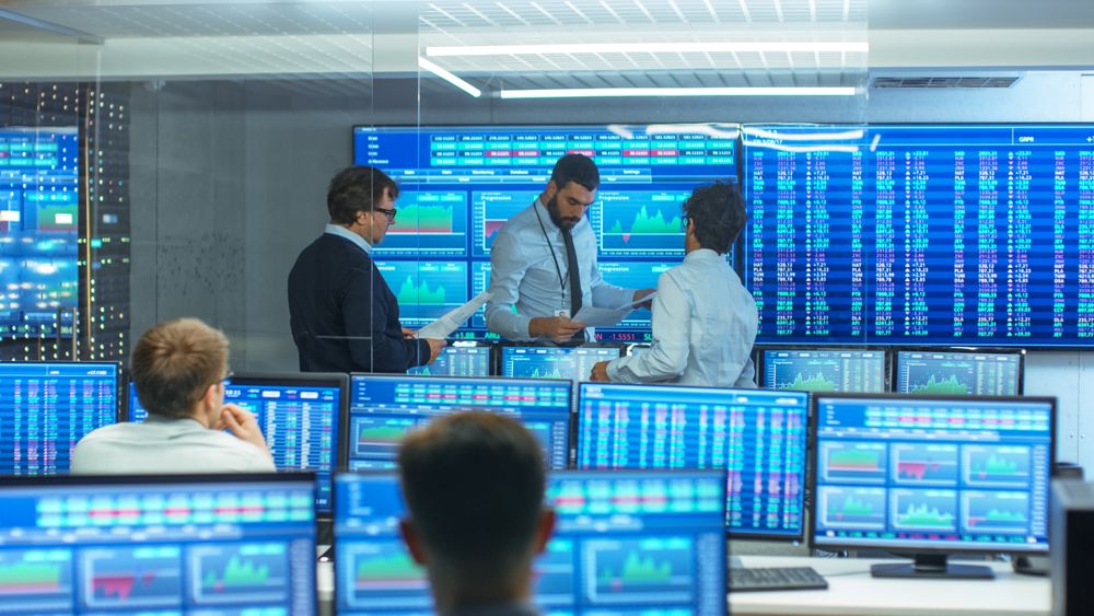 Three Experienced Stock Traders Talking Business, Consulting Documents and Argue About Data.