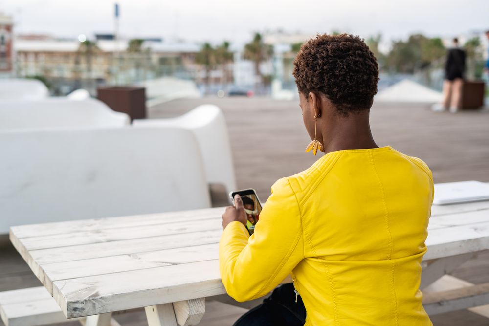 Focused woman using mobile at desk